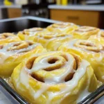 - 4 cups all-purpose flour - 1 packet (2 ¼ teaspoons) active dry yeast - 1 cup whole milk, warmed - 1/3 cup granulated sugar - 1/4 cup unsalted butter, melted - 2 large eggs - 1 teaspoon salt - 1 tablespoon ground cinnamon - 1/2 cup brown sugar, packed - 1/4 cup unsalted butter, softened - 1/2 cup maple syrup - 1 cup powdered sugar (for icing) - 2 tablespoons milk (for icing) - Alternatives for all-purpose flour: You can use whole wheat flour or a gluten-free blend. Just ensure the gluten-free mix has xanthan gum for better texture. - Vegan options for butter and milk: Use coconut oil instead of butter and almond or oat milk for dairy-free needs. - Sweetener alternatives: You can replace granulated sugar with coconut sugar or agave syrup for a healthier option. Activating the yeast mixture Start by warming your milk. It should feel warm, not hot. In a small bowl, mix the warm milk with sugar. Then, sprinkle the yeast over the milk. Let it sit for about five minutes. The yeast should get frothy and bubbly. This shows it is alive and ready to work its magic. Mixing and kneading the dough In a large bowl, whisk together three cups of flour, salt, and cinnamon. This blend adds flavor and structure. Next, add your frothy yeast mixture, melted butter, and eggs. Stir them until well combined. Gradually add the last cup of flour. Knead the dough on a floured surface for five to seven minutes. You want it to be smooth and elastic. This step is key for soft rolls. Shaping the dough into a rectangle Once your dough rises, roll it out on a floured surface. Aim for a rectangle about 16 by 24 inches. Use a rolling pin for even thickness. This shape helps with even filling and rolling. Spreading butter and adding the filling Spread the softened butter over the entire surface of the dough. This butter will make each bite rich. In a bowl, mix brown sugar and cinnamon. Sprinkle this mixture evenly over the butter. Drizzle maple syrup on top for that sweet flavor. Cutting the dough and preparing for the second rise Starting from one long edge, roll the dough tightly into a log. Pinch the edge to seal. Cut the log into 12 equal pieces. Place these rolls in a greased baking dish. Cover them and let them rise for another 30 to 45 minutes. This second rise makes the rolls fluffy. Baking and achieving golden brown color Preheat your oven to 350°F (175°C). Bake the rolls for 25 to 30 minutes. They should turn golden brown on top. This color means they are ready to eat. Enjoy the warm smell filling your kitchen! To get those soft, fluffy rolls, you need a warm rising spot. Yeast loves warmth. It helps the dough rise well. Use a warm oven or a sunny spot in your home. This small step makes a big difference. Kneading is key for great texture. I recommend kneading the dough for about 5-7 minutes. It should feel smooth and elastic. Don’t rush this part. Proper kneading helps the rolls rise and get fluffy. For smooth icing, whisk the powdered sugar and milk well. This mix should be creamy and lump-free. You want it to drizzle easily over your rolls. Take your time to get it right. Timing for icing is important. Apply the icing while the rolls are warm. This way, it melts slightly and seeps into the rolls. It makes every bite taste even better! One common mistake is over-proofing the dough. This can make the rolls too airy and collapse. Keep an eye on the time and check the dough. It should double in size, not overflow. Another mistake is underbaking the rolls. If they are gooey in the center, they need more time. Aim for a nice golden brown color. This shows they are baked perfectly. {{image_2}} You can make these rolls even more exciting. Try adding chocolate chips. They melt and make each bite rich. You can also mix in chopped nuts. Walnuts or pecans add a nice crunch. Another fun twist is to use flavored extracts. You can swap vanilla for maple. Almond extract also adds a nice touch. Need a gluten-free option? Use a gluten-free flour blend. Make sure it has xanthan gum for structure. For a dairy-free version, swap whole milk with almond or oat milk. You can use dairy-free butter too. These swaps keep the rolls soft and fluffy. Want to dress up your rolls? You can sprinkle nuts or fruits on top. Chopped apples or pecans look pretty and taste great. For unique icing flavors, add spices or citrus zest. Try orange zest for a fresh twist. Each choice makes your rolls special and tasty! To keep your rolls fresh, place them in an airtight container. You can refrigerate them for up to four days. If you want to store them longer, consider freezing. Here’s how: - Wrap each roll in plastic wrap. - Place the wrapped rolls in a freezer-safe bag. - They can stay frozen for up to three months. This method keeps them moist and tasty for later enjoyment. When you want to enjoy your rolls again, reheating is key. Here are some simple steps: - Preheat your oven to 350°F (175°C). - Place the rolls on a baking sheet and cover with foil. - Heat for about 10-15 minutes. This method keeps the rolls soft and warm. You can also use the microwave: - Place a roll on a microwave-safe plate. - Cover it with a damp paper towel. - Heat for 10-15 seconds. This helps avoid drying out your rolls. Enjoy that fresh, bakery taste! Bakery-style maple cinnamon rolls stay fresh for about 2 to 3 days at room temperature. After that, they may dry out. To keep them soft, store them in an airtight container. You can also wrap them in plastic wrap. If you want them to last longer, freeze them. They can stay good in the freezer for up to 3 months. Yes, you can make these rolls ahead of time. You can prepare the dough the night before. After kneading, place the dough in the fridge. Let it rise overnight. In the morning, you can roll, fill, and bake them. This way, you have fresh rolls without much morning prep time. The best way to store cinnamon rolls is at room temperature in an airtight container. This keeps them soft and moist. If you want to keep them for longer, you can freeze them. Wrap each roll well in plastic wrap and place them in a freezer bag. Yes, you can use instant yeast instead of active dry yeast. Instant yeast works faster, so you can skip the proofing step. Just mix it directly with the dry ingredients. This saves you time and still gives you soft and sweet rolls. To tell when the rolls are done baking, look for a golden brown color on top. You can also tap the bottom of a roll. If it sounds hollow, it’s done. The internal temperature should reach about 190°F (88°C) for perfect rolls. Making maple cinnamon rolls is simple and fun. You’ve learned about key ingredients, step-by-step instructions, and tips for success. Remember to experiment with flavors and ensure proper baking techniques. Store your leftover rolls correctly to keep them fresh. With these insights, you can create delicious rolls that impress everyone. Enjoy baking and share your tasty results!