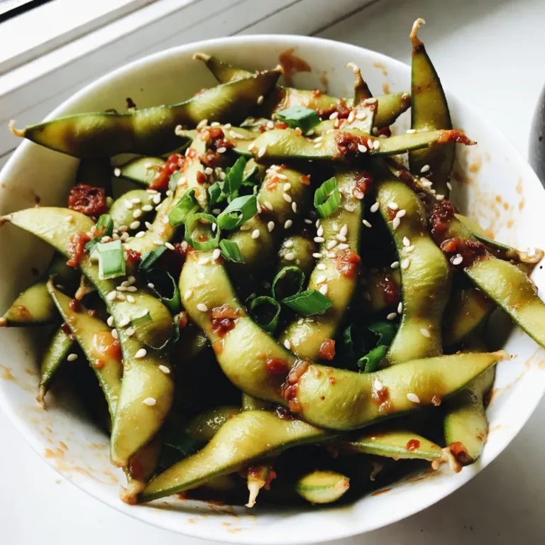 - 2 cups edamame pods (fresh or frozen) - 3 tablespoons olive oil - 4 cloves garlic, minced - 1-2 tablespoons chili paste (adjust for spiciness) - 1 tablespoon soy sauce - 1 teaspoon sesame oil - 1/2 teaspoon sea salt - 1 tablespoon sesame seeds - Chopped green onions for garnish (optional) This recipe starts with the main ingredients. Edamame pods are the star. You can use fresh or frozen. Olive oil adds richness and flavor. Garlic brings a strong taste that pairs well with edamame. Next, we have the seasoning ingredients. Chili paste gives the dish its heat. You can adjust this based on how spicy you want it. Soy sauce adds depth, while sesame oil gives a nutty touch. Lastly, the garnish ingredients finish the dish. Sea salt enhances all flavors. Sesame seeds add crunch and a bit of style. Green onions add color and freshness, making your dish pop. When you combine all these ingredients, you create a snack that is both tasty and simple. Enjoy making this spicy garlic edamame! {{ingredient_image_1}} How to cook frozen edamame To cook frozen edamame, follow the package's instructions. Usually, you boil it in water. Cook until tender, which takes about 5-7 minutes. After cooking, drain the edamame and set it aside. Boiling fresh edamame If you have fresh edamame, bring a pot of salted water to a boil. Add the pods and cook them for 5-6 minutes. They should be bright green and tender. Once done, drain and set aside. Sautéing garlic In a large skillet, heat 3 tablespoons of olive oil over medium heat. After a minute, add 4 cloves of minced garlic. Sauté the garlic for 1-2 minutes until it smells great. Be careful not to burn it, or it will taste bitter. Creating the spicy garlic sauce Next, stir in 1-2 tablespoons of chili paste and 1 tablespoon of soy sauce. Mix well until you have a smooth spicy garlic sauce. The amount of chili paste can change how hot the dish is. Tossing edamame in the sauce Now, add the cooked edamame to the skillet. Toss the edamame in the sauce, coating them well. Stir-fry for about 3-4 minutes. This time helps the flavors mix together. Final steps before serving Drizzle 1 teaspoon of sesame oil over the edamame. Sprinkle with 1/2 teaspoon of sea salt. Toss everything one last time to combine well. Then, remove from heat and transfer the dish to a serving bowl. Garnish with sesame seeds and chopped green onions if you like. Enjoy your spicy garlic edamame! To make spicy garlic edamame pop, adjust the chili paste. Start with one tablespoon for a mild kick. If you love heat, add more. Taste as you go! This way, you control the spice level. Be careful when cooking the garlic. Sauté it for just 1-2 minutes. Burning it makes it bitter. You want a rich, warm flavor, not a charred taste. Patience is key here! Garnish your spicy garlic edamame with sesame seeds. This adds a nice crunch. The seeds contrast well with the tender edamame. Chopped green onions also add freshness. Sprinkle them on just before serving. They brighten up the dish both in flavor and color. Your guests will love the visual appeal! Use a large skillet for even cooking. A non-stick one works best. It helps prevent sticking and burning. A timer is your best friend. Set it for 1-2 minutes when sautéing garlic. This way, you avoid burning. It ensures your edamame cooks perfectly every time! Pro Tips Fresh vs. Frozen: If using frozen edamame, ensure they are fully thawed for even cooking. Fresh edamame will provide a better texture and taste. Adjust the Heat: Start with 1 tablespoon of chili paste and taste before adding more. This allows you to control the spice level according to your preference. Perfectly Sautéed Garlic: Keep an eye on the garlic while sautéing. It can go from fragrant to burnt very quickly, impacting the overall flavor. Garnishing Tips: For an added crunch, toast the sesame seeds before sprinkling them on top of the edamame. This enhances their flavor and adds a delightful texture. {{image_2}} You can make spicy garlic edamame mild or hot. For a mild version, use less chili paste. Start with one tablespoon and taste. If you want more heat, add more chili paste slowly. This way, you can find the right level for you. It makes the dish fun and personal. Get creative by adding other veggies. Peppers or carrots can add color and crunch. You can also boost the protein. Try adding tofu or shrimp. Just cook them in the skillet before the edamame. This makes the dish even heartier and more filling. Spicy garlic edamame works great as an appetizer. Serve it warm with drinks or as a starter. You can also pair it with rice dishes or noodles. It complements Asian flavors very well. Enjoy this tasty snack anytime! To keep your spicy garlic edamame fresh, store it in the fridge. Place it in an airtight container. This helps lock in flavor and keep it safe. Make sure to eat it within three days for the best taste. You can easily reheat spicy garlic edamame in a skillet. Heat the skillet over medium heat. Add the edamame and stir for a few minutes until warm. This method keeps the texture nice. If you prefer microwaving, place edamame in a microwave-safe bowl. Cover it with a damp paper towel. Heat in short bursts, about 30 seconds. Stir and check until hot. You can freeze the prepared edamame for later use. Let it cool completely first. Then, place it in a freezer-safe bag. Squeeze out excess air to prevent freezer burn. When you’re ready to eat, thaw it in the fridge overnight. You can also use the microwave for quicker thawing. Just be careful not to cook it too long. Cooking edamame is quick and easy. If you use frozen edamame, it usually takes about 5-7 minutes. Simply follow the package instructions. For fresh edamame, boil it in salted water for 5-6 minutes until tender. Both methods ensure you get that lovely flavor and texture. Yes, you can! While I love using olive oil for its taste, you can try other oils too. Avocado oil adds a nice flavor, and sesame oil gives a rich taste. Coconut oil works well if you want a hint of sweetness. Just pick an oil that matches your flavor goals. Absolutely! Edamame is packed with nutrition. It is high in protein and low in calories. One cup of edamame has about 120 calories and contains 11 grams of protein. It also provides fiber, vitamins, and minerals. Eating edamame is a tasty way to add healthy nutrients to your diet. This blog post covered how to cook and enjoy a tasty edamame dish. We explored key ingredients and provided easy steps to make it at home. You learned tips to enhance flavor and how to present your meal well. If you want to adapt the recipe, we shared ways to change spice levels and add ingredients. Lastly, we showed how to store leftovers and reheat them. Enjoy experimenting with different flavors and serving ideas. Your kitchen is now ready for a healthy, delicious treat!