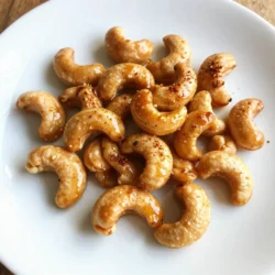 - 2 cups raw cashews - 2 tablespoons honey - 2 tablespoons Sriracha sauce - 1 tablespoon olive oil - 1 teaspoon garlic powder - 1/2 teaspoon salt - 1/4 teaspoon black pepper - 1/4 teaspoon smoked paprika (optional) Each ingredient plays a big role in flavor and texture. - Raw cashews: These nuts are crunchy, creamy, and full of healthy fats. They form the base of our snack. - Honey: This natural sweetener adds a nice balance to the spicy Sriracha. It also helps the nuts caramelize. - Sriracha sauce: This hot sauce gives the cashews a kick. It has garlic and vinegar, adding depth to the flavor. - Olive oil: This keeps the cashews moist and helps the spices stick. - Garlic powder: This adds a savory taste that complements the heat from Sriracha. - Salt: A must to enhance all the flavors. - Black pepper: This adds a subtle heat to the mix. - Smoked paprika: Optional, but it adds a smoky flavor. It can make the snack even more interesting. You might not have some ingredients at home. Here are some easy swaps. - Cashews: Use almonds or walnuts for a different crunch. - Honey: Maple syrup or agave syrup can work well if you're vegan. - Sriracha: Hot sauce or chili paste can replace Sriracha if you need a milder option. - Olive oil: Any neutral oil like canola or avocado oil will work fine. - Garlic powder: Fresh minced garlic can be used, but use less for less strong flavor. - Smoked paprika: Regular paprika works too if you lack smoked flavor. These swaps keep the spirit of the recipe alive while catering to your pantry. Enjoy making this tasty snack! {{ingredient_image_1}} Start by preheating your oven to 350°F (175°C). This temperature is key for a perfect roast. While the oven heats, line a baking sheet with parchment paper. This paper helps the nuts not stick and makes cleanup easy. In a large bowl, mix these ingredients: - 2 tablespoons honey - 2 tablespoons Sriracha sauce - 1 tablespoon olive oil - 1 teaspoon garlic powder - 1/2 teaspoon salt - 1/4 teaspoon black pepper - 1/4 teaspoon smoked paprika (optional) Stir well until everything blends together. This mixture gives the cashews a sweet and spicy kick. Now, add 2 cups of raw cashews to your bowl. Toss them with the Sriracha honey coating until they are fully covered. Make sure every nut gets a good amount of that zesty mix. This step is where the magic happens. Spread the coated cashews in a single layer on your baking sheet. Bake them in the oven for 15-20 minutes. Stir them every 5 minutes. This helps them roast evenly and prevents burning. They are ready when they turn golden brown and smell amazing. Let them cool on the sheet. They will get crunchier as they cool, making them a delightful snack. To get that perfect crunch, roast the cashews until they turn golden brown. This usually takes about 15-20 minutes. Stir them every five minutes. This helps them roast evenly and prevents burning. After you take them out of the oven, let them cool on the baking sheet. Cooling is key, as the cashews will get crunchier as they sit. If you like it hot, add more Sriracha to the mix! Try starting with one tablespoon. Then taste it before you add the cashews. You can also cut back on the Sriracha if you want less heat. A touch of honey can balance the spice. Don't be afraid to play with the spice level to fit your taste. Sriracha honey roasted cashews make a great snack on their own. Try serving them in small bowls at parties. You can also mix them into a trail mix. Pair them with cheese or crackers for a fun appetizer. These cashews also work as a topping for salads or grain bowls. The options are endless, so get creative! Pro Tips Use Fresh Cashews: For the best flavor and crunch, choose fresh, high-quality raw cashews. Stale nuts can affect the taste and texture. Adjust the Heat: If you prefer a milder snack, reduce the amount of Sriracha. Start with one tablespoon and adjust to your taste. Experiment with Spices: Feel free to add other spices such as cayenne pepper or chili powder for extra heat, or even cinnamon for a sweet twist. Store Properly: Keep leftovers in an airtight container at room temperature to maintain their crunchiness. They can last up to a week. {{image_2}} You can easily play with the sweetness and heat. Try adding a touch of brown sugar for extra sweetness. You can also mix in some cayenne pepper for a bolder spice. A dash of cinnamon adds warmth and depth. These small tweaks make a big difference in taste. Not a fan of cashews? No problem! Almonds and pecans work great too. They add a different crunch and flavor. You can even mix nuts to create a nut medley. If you want a nut-free option, sunflower seeds are a good choice. They also roast well and soak up flavors nicely. Add herbs and spices to change the vibe of your snack. Fresh rosemary or thyme can add a nice herbal note. For a twist, consider adding chili flakes or cumin for a unique flavor. You can also use lemon zest for a fresh, zesty kick. Experiment with your favorite herbs to find the perfect blend. To keep your Sriracha honey roasted cashews fresh, store them in an airtight container. A glass jar or a sealed plastic bag works well. Keep them in a cool, dry place away from light. This helps maintain their crunch and flavor. Homemade cashews can last about two weeks. After that, they may lose their crunch. If you want to keep them longer, you can freeze them. In the freezer, they can last up to six months. Just remember to thaw them before serving. If your cashews lose some crunch, you can reheat them. Spread them on a baking sheet and warm them in the oven at 350°F for about 5-10 minutes. Keep an eye on them to prevent burning. This will help bring back their crispiness and flavor. Enjoy your snack! Homemade Sriracha honey roasted cashews last about two weeks. Store them in an airtight container. This keeps them fresh and crunchy. If you want them to last longer, you can freeze them. Just make sure to seal them well. They can stay good for up to three months in the freezer. Yes, you can make Sriracha honey roasted cashews in a microwave. Use a microwave-safe bowl. Mix the honey, Sriracha, and spices as usual. Add the cashews, then stir to coat. Microwave them in short bursts, about one to two minutes. Stir after each burst to prevent burning. Keep an eye on them until they look golden. You can serve Sriracha honey roasted cashews in many fun ways. They work great as a snack on their own. You can add them to salads for a crunch. They also make a good topping for soups. Try them in trail mix for a sweet and spicy kick. You can even serve them with cheese and crackers. Sriracha honey roasted cashews can be a healthy snack. Cashews provide protein and healthy fats. Honey offers natural sweetness, while Sriracha adds flavor without too many calories. Just watch the portion size. They can be high in calories if eaten in large amounts. Enjoy them as part of a balanced diet for the best benefits. You now know how to make Sriracha honey roasted cashews, from start to finish. We covered key ingredients, their best substitutes, and how to achieve that perfect crunch. You learned roasting tips and ways to store cashews for freshness. Explore variations to keep it interesting or adjust the spice to fit your taste. Enjoy making these tasty snacks. They are great for sharing or just for you! Your kitchen will have a wonderful smell, and your taste buds will thank you. Happy roasting!
