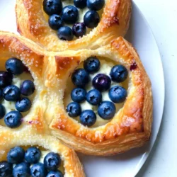 - 1 sheet of puff pastry, thawed - 4 oz cream cheese, softened - 1/3 cup powdered sugar - 1 teaspoon vanilla extract - 1 cup fresh blueberries - 1 tablespoon lemon juice - 1 egg, beaten (for egg wash) - 1 tablespoon coarse sugar (for topping) These ingredients create a rich and tasty treat. The puff pastry gives a flaky base. Cream cheese adds creaminess and sweetness. Fresh blueberries offer a burst of flavor and color. - Zest of 1 lemon - A pinch of salt - Ground cinnamon Adding lemon zest brightens the taste. A pinch of salt balances the sweetness. Ground cinnamon can add warmth and depth. - Baking sheet - Parchment paper - Rolling pin - Mixing bowls - Whisk - Pastry brush You need basic kitchen tools for this recipe. A baking sheet and parchment paper help with easy cleanup. A rolling pin smooths the puff pastry. Mixing bowls and a whisk combine ingredients well. A pastry brush applies the egg wash for a golden finish. {{ingredient_image_1}} Start by preheating your oven to 400°F (200°C). Line a baking sheet with parchment paper. Next, take your thawed puff pastry and place it on a lightly floured surface. Roll it out gently to smooth it and make it a bit larger. Cut the pastry into four equal squares. This will be the base for your danishes. In a medium bowl, grab your softened cream cheese. Add in the powdered sugar and vanilla extract. Mix them together until the mixture is smooth and creamy. This filling is rich and sweet, perfect for your pastry. Now, it’s time to put everything together. Take one pastry square and place a generous dollop of the cream cheese mixture in the center. In another bowl, toss your fresh blueberries with lemon juice. Spread the blueberries evenly over the cream cheese. Fold the corners of each pastry square toward the center, pinching to seal. Leave the center exposed for a nice look. Brush the edges with beaten egg for a golden finish. Sprinkle coarse sugar on top for sweetness and crunch. Finally, bake in the oven for 15-20 minutes, until they are puffed and golden brown. Let them cool slightly before serving. Enjoy! To get the best puff pastry, choose a good brand. Thaw the pastry slowly in the fridge. This keeps it cold and helps it puff up nicely. Roll it out gently on a floured surface. You want it to be even, not too thin. Cut it into equal squares to help with even baking. For a smooth cream cheese filling, make sure it is soft. Let it sit out for a bit before mixing. Combine the cream cheese, powdered sugar, and vanilla in a bowl. Mix well until it is creamy. If you want it sweeter, add more powdered sugar. The lemon juice mixed with the blueberries adds a nice zing. Set your oven to 400°F (200°C) for best results. This high heat helps the pastries puff up and turn golden. Bake them for 15 to 20 minutes. Keep an eye on them. You want a nice golden color. If they are not brown after 20 minutes, give them a few more. Enjoy the smell that fills your kitchen! Pro Tips Keep the Puff Pastry Cold: Ensure the puff pastry remains cold before baking for the best rise and flakiness. Variations with Fruit: Experiment with different fruits like raspberries or strawberries for a unique twist on flavor. Egg Wash for Shine: A thorough egg wash not only gives a golden color but also adds a beautiful shine to the pastries. Serving Temperature: These danishes are best served warm, as the cream cheese filling will be soft and creamy. {{image_2}} You can swap blueberries for other fruits. Try raspberries, strawberries, or peaches. Each fruit adds a unique taste. Raspberries give a tart flavor, while peaches add sweetness. Adjust the lemon juice for balance. Keep the same filling for easy swaps. You can change the cream cheese flavor too. Add lemon zest for a fresh twist. Use almond extract for a nutty hint. For a chocolate touch, mix in cocoa powder. Each choice will create a new flavor profile. Get creative with your favorite tastes! Puff pastry is great, but you can use others. Try Danish dough for a richer taste. Croissant dough gives a buttery flavor. Biscuit dough can work in a pinch. Each type will change the texture. Experiment to find your perfect match! To keep your blueberry cream cheese danish fresh, store it in an airtight container. Make sure it cools fully before sealing it. Place the container in the fridge. Leftovers stay good for up to three days. If you want to keep it longer, consider freezing. When you're ready to enjoy leftovers, preheat your oven to 350°F (180°C). Place the danish on a baking sheet. Heat for about 10-15 minutes. This will help it regain its crispiness. You can also use a microwave, but it may not be as crispy. Heat for 20-30 seconds, checking often. To freeze, wrap each danish tightly in plastic wrap. Then, place them in a freezer-safe bag. They can last up to three months in the freezer. When you’re ready to eat, thaw them overnight in the fridge. Reheat as described above for the best taste and texture. You can prepare the filling and pastry in advance. Make the cream cheese mix and store it in the fridge. Roll and cut the puff pastry squares the night before. Keep them in the fridge, covered with plastic wrap. On baking day, just fill them and bake. This saves time and gives you fresh danishes quickly. Yes, you can use frozen blueberries. They work well in this recipe. Just let them thaw and drain any extra juice. This keeps the filling from getting too watery. Frozen blueberries may not be as firm as fresh ones. However, they still taste great and add nice flavor. These danishes pair well with coffee or tea. You can also serve them with fresh fruit. A scoop of vanilla ice cream is a fun touch too. For extra flavor, add a drizzle of honey or a light glaze. This adds sweetness and makes your dessert even more special. You’ve learned how to make a delicious blueberry cream cheese Danish. We covered all the key ingredients, step-by-step instructions, and handy tips. Remember, puff pastry is key for that perfect crunch. Experiment with different fruits or cream cheese flavors to mix things up. Finally, proper storage will keep your danishes fresh longer. I hope you enjoy baking these tasty treats as much as I do!